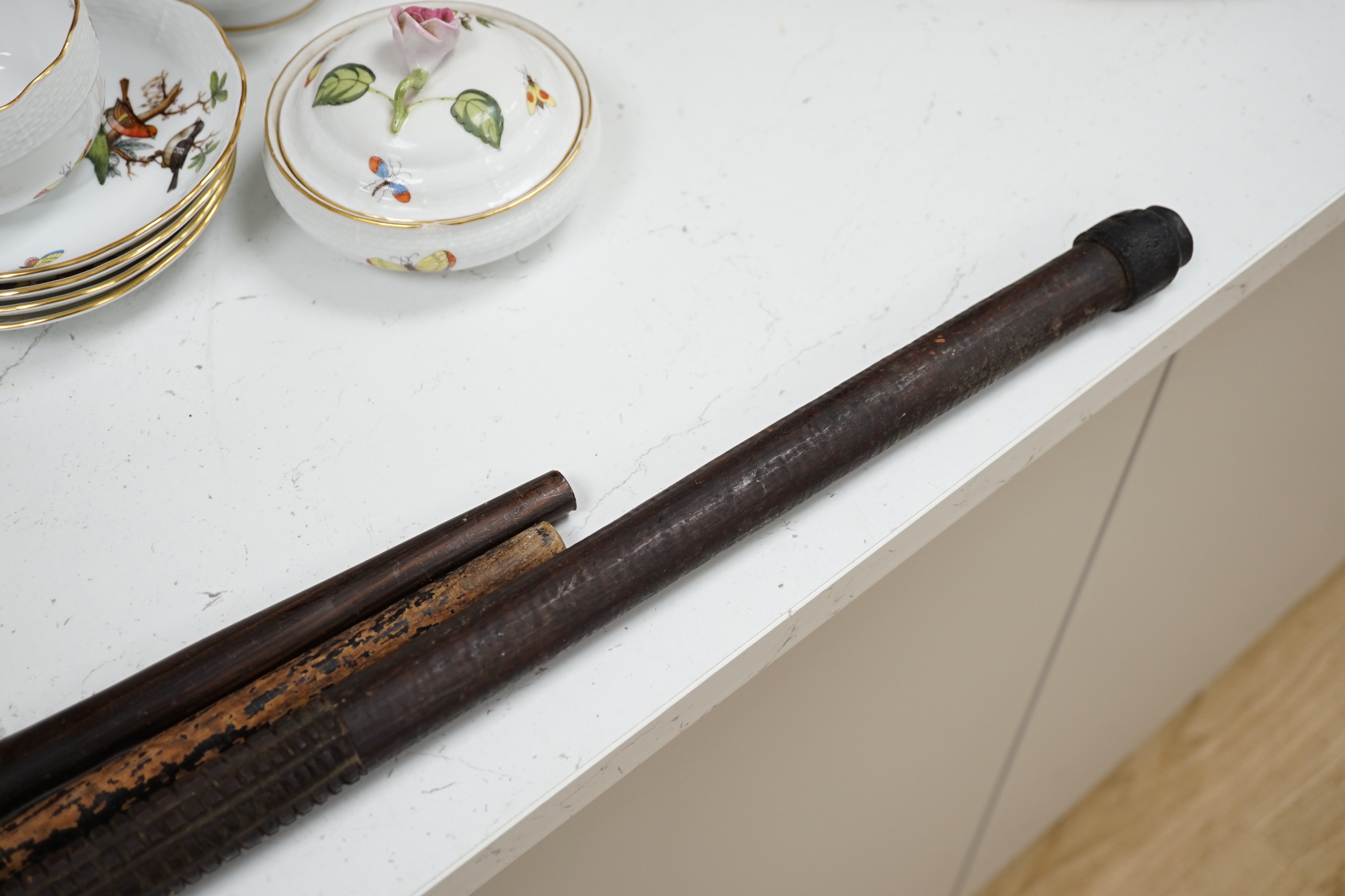 A silver topped walking cane and two African carved wood canes
